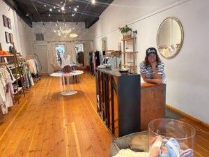 A boutique with a woman standing at the counter.