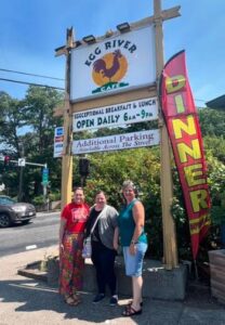 Community Foundation employees with RR Director, Julianna Dodson under the Egg Cafe sign.