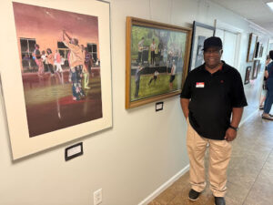 A man standing in front of his art.